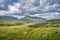 Molls Gap illuminated by sunlight with Owenreagh River valley and MacGillycuddys Reeks mountains