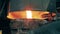 Molten copper is pouring into a steel ladle