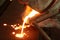 molten metal pouring in sand mold ; green sand process