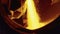 Molten raw materials in furnace. Stock footage. Close-up of bright molten substance pouring out in stream in industrial