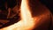 Molten raw materials in furnace. Stock footage. Close-up of bright molten substance pouring out in stream in industrial
