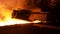Molten steel pouring process with steam clubs at metallurgical plant. Stock footage. Close up fot steel pouring machine.