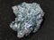 Molybdenite crystal in rough Glaucophane on dark