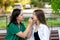 Mom applying lipstick to teenage daughter\\\'s lips