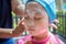 Mom applying sunscreen on girl face before swim