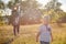 Mom and baby blow soap bubbles on a sunny meadow in summer