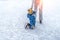 Mom with baby boy 3-5 years old, learn train, ride winter city rink, ice skating. The child gets up, fell on skates