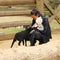 Mom with baby in kids` ZOO petting sheep