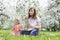 Mom with beautiful daughter blowing soap bubbles