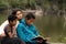 Mom and Boys Studying the Bible by River Front