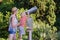 Mom and child boy look through binoculars for tourists at viewpoint on Park background