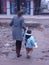 Mom and child crossing muddy road