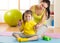 Mom and child daughter engage in fitness dumbbells