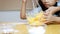 Mom and child hands are preparing and arranging cookie dough before baking process