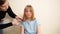 Mom cuts her daughter's wet hair. cutting hair at home.