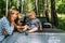 Mom, dad and little son in a convertible car. Summer family road trip to nature