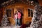 Mom and dad pose with their charming little daughter in decorated christmas studio. New Year photo session