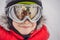 Mom and Dad are reflected in the boy ski goggles. Mom and Dad teach a boy to ski or snowboard