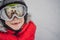 Mom and Dad are reflected in the boy ski goggles. Mom and Dad teach a boy to ski or snowboard