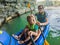 Mom, dad and son travelers rowing on a kayak in Halong Bay. Vietnam. Travel to Asia, happiness emotion, summer holiday