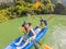 Mom, dad and son travelers rowing on a kayak in Halong Bay. Vietnam. Travel to Asia, happiness emotion, summer holiday