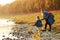 Mom with daughter in autumn. Mother and daughter walking near river in autumn time. Happy family. Fall weekend in the open air. Fa