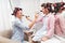 Mom and daughter in a beauty salon. They have curlers in their hair. Mother and daughter make makeup to each other.