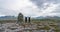 Mom and daughter celebrates on a mountain top next to a cairn with beautiful mountain view of Rondane national park in Norway.