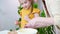 Mom and daughter cheerfully cook together cupcakes and taste the dough