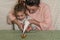 Mom and daughter decorate gingerbread with icing