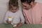 Mom and daughter decorate gingerbread with icing