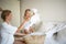 Mom and daughter disassemble a wicker basket of laundry