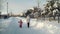 Mom and daughter doing nordic walking in the suburbs in winter.