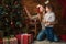 Mom and daughter dress up a Christmas tree