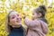 Mom and daughter. the girl tries to take off sunglasses from her mother. sunglasses in the shape of heart