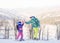 Mom and daughter give high five while snow skiing