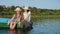 Mom with daughter in hats sail in a wooden boat