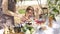 Mom and daughter have breakfast outdoors in the apple orchard in the spring. Happy family concept