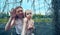 Mom and daughter hold on to the torn net from the goalkeeper`s gate. Summer day for sports and outdoor walks