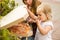 Mom and daughter open a box of pizza. A little girl licks her finger