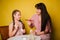 Mom and daughter paint eggs for Easter. A believing woman and a child girl preparing for a religious holiday