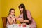 Mom and daughter paint eggs for Easter. A believing woman and a child girl preparing for a religious holiday