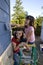 Mom and Daughter Painting a House - Vertical