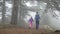 Mom and daughter are on the path of Aphrodite in the mountains. Cedars, thick fog