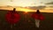 Mom and daughter play super heroes in red cloaks at sunset in the park. Girls play superheroes running across the field