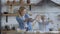 Mom and daughter are preparing a pie in the kitchen. woman and girl clap their hands and flour flies through the kitchen