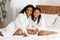 Mom And Daughter Relax. Little Black Girl And Mother Posing In Bathrobes