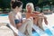 mom and daughter while relaxing in a whirlpool tub inside a swimming pool