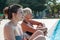 mom and daughter while relaxing in a whirlpool tub inside a swimming pool