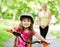 Mom and daughter ride bikes in the forest